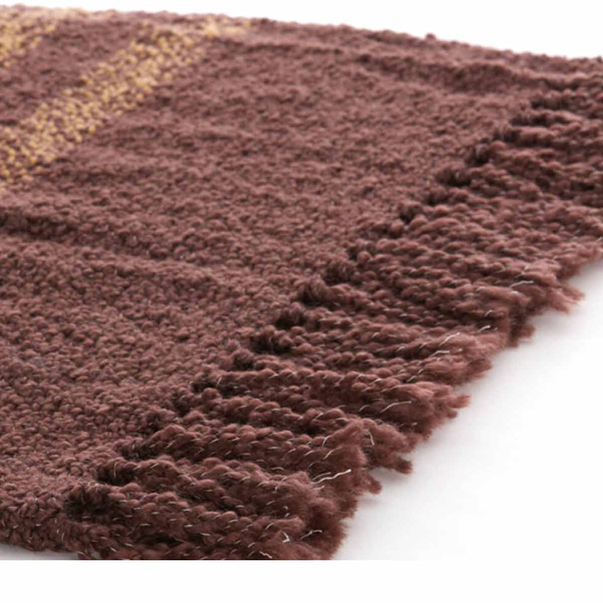 Braza Throw in dark brown with ochre accents - close up of fringed edge and textured design