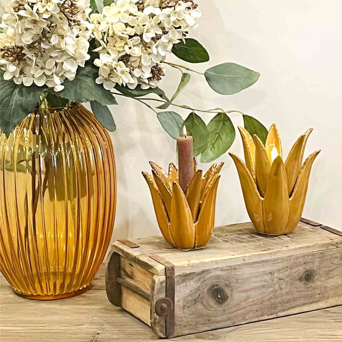 Cactus Ceramic Candle Holder in ochre, styled with a ribbed amber glass vase, faux florals, and a rustic wooden display box.