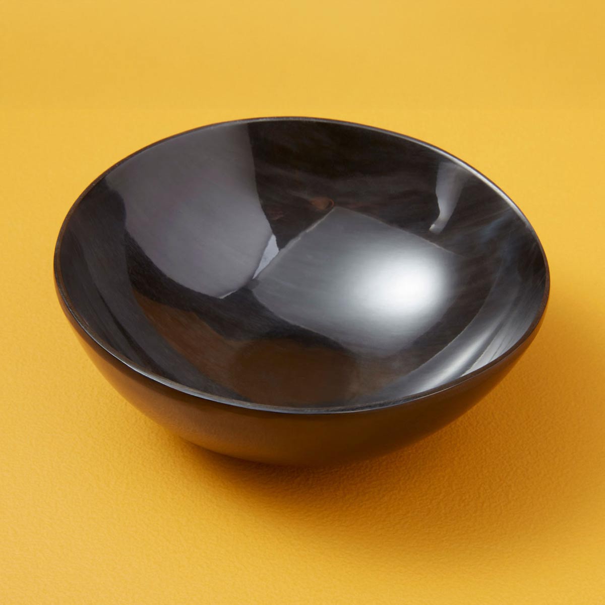 Handcrafted Medium Black Horn Bowl made from ethically sourced water buffalo horn, featuring a smooth, polished finish and unique natural patterns. Ideal for serving or decor.