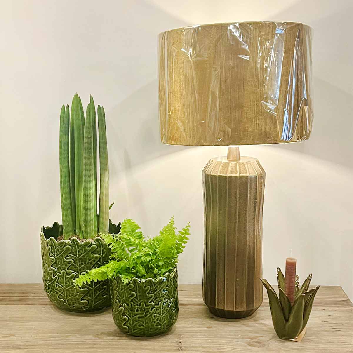  Levy Antique Bronze Lamp with Gemstone Gold Shade, styled with green ceramic planters and a dark green cactus candle holder.