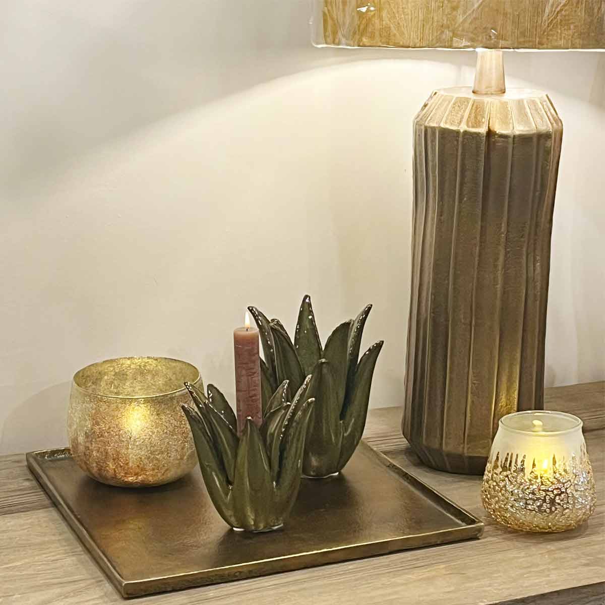 Styled Maes Square Candle Plate in Antique Bronze with candles and decorative accents on a wooden table.