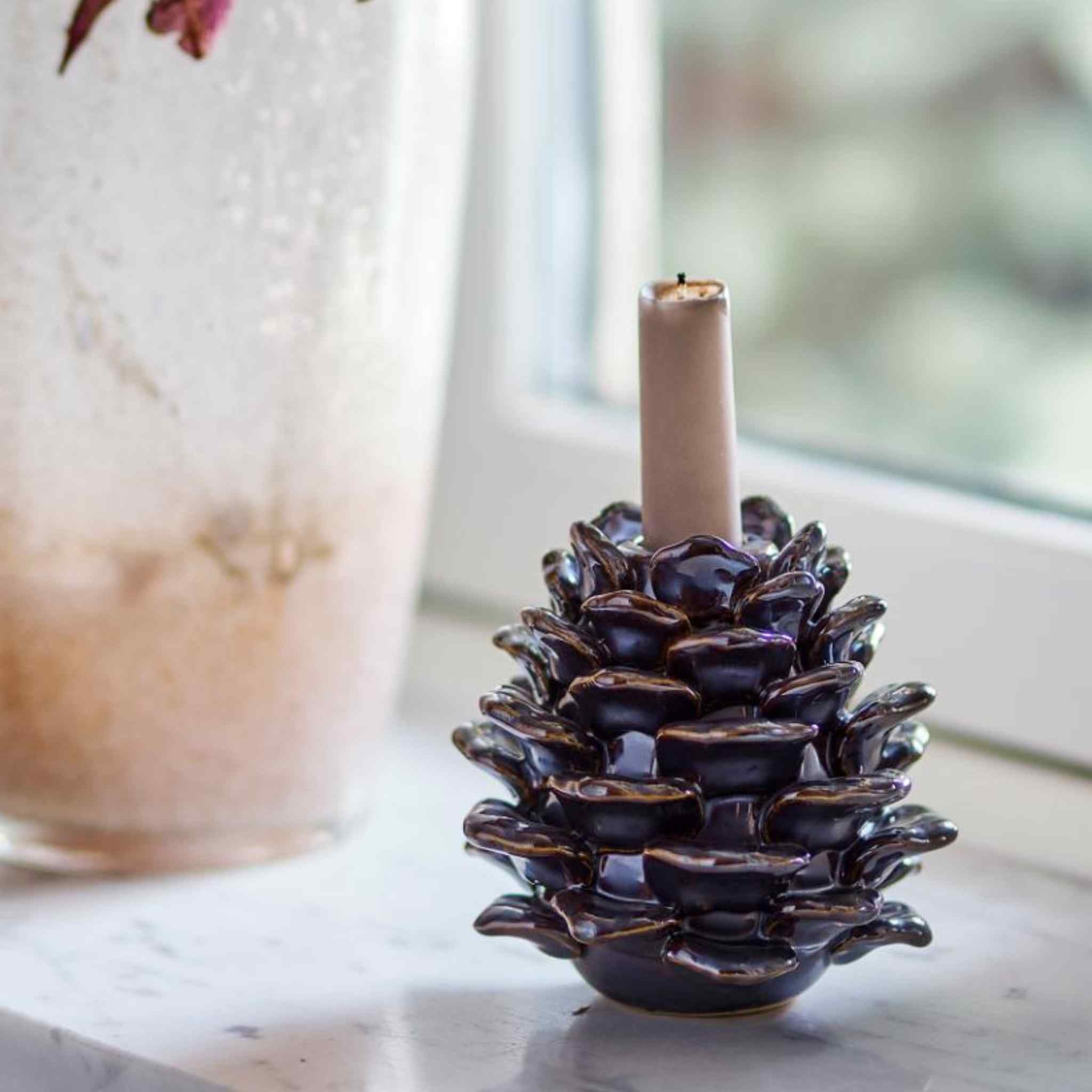 Large Pine Cone Candle Holder - Brown Stoneware - Displated on window with candle