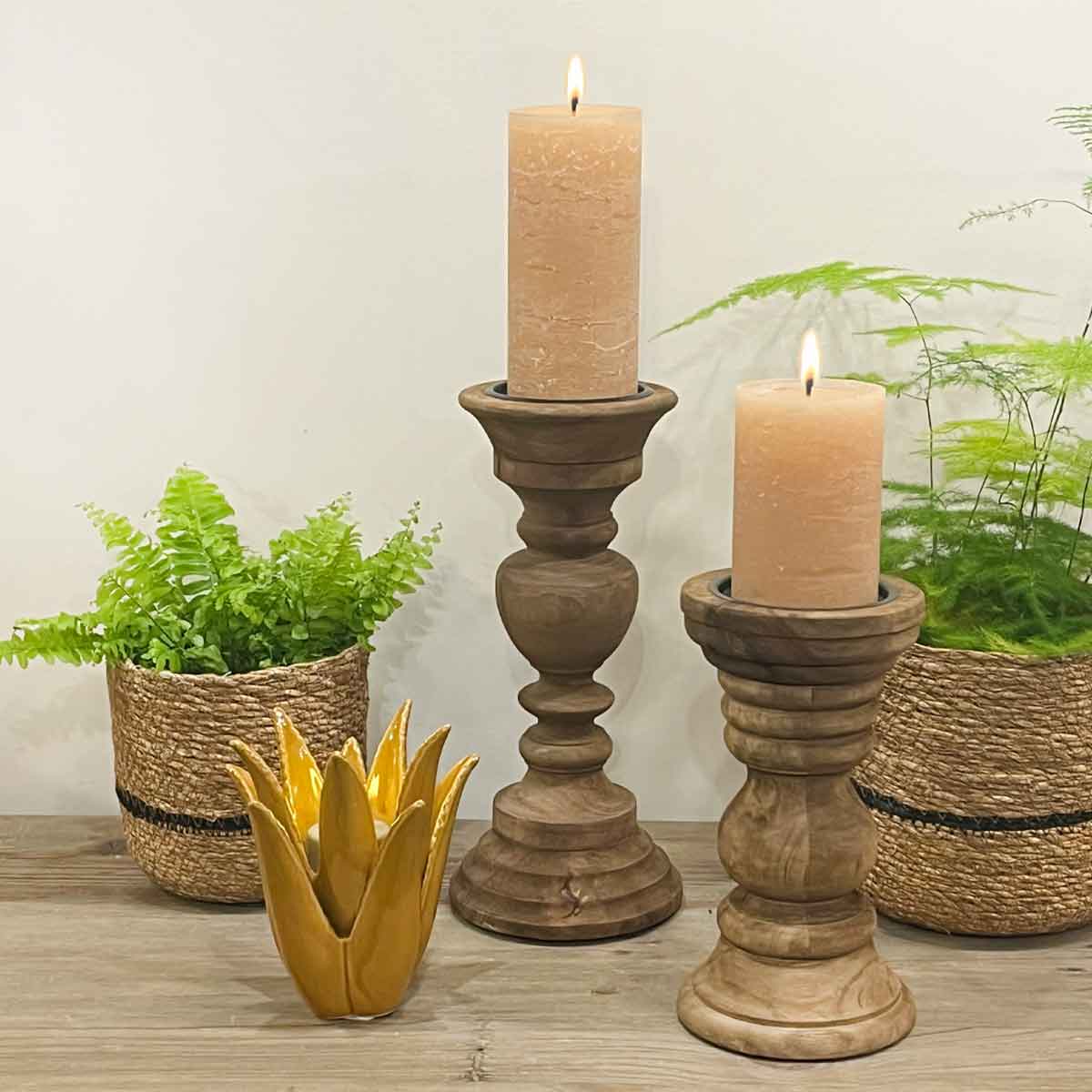 Ravenna and Pescara Mango Wood Candle Holders pictured together, styled with pillar candles, an ochre tealight holder, and woven planters on a wooden surface.